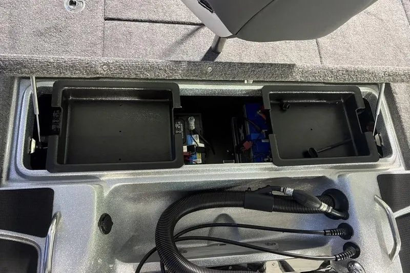 Slide: The Image of 2024 Phoenix 920 Elite boat storage compartments and battery setup. - 30