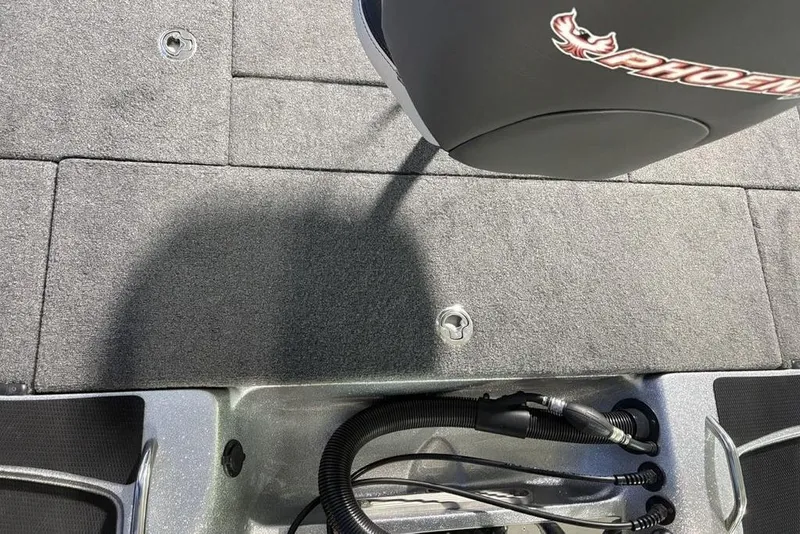 Slide: The Image of 2024 Phoenix 920 Elite boat interior with carpeted deck and wiring details. - 33