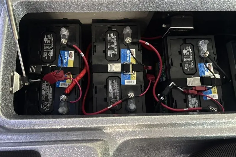 Slide: The Image of 2024 Phoenix 920 Elite battery compartment with three deep cycle batteries and wiring. - 34