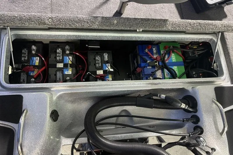 Slide: The Image of 2024 Phoenix 920 Elite boat battery compartment with multiple batteries and wiring. - 35