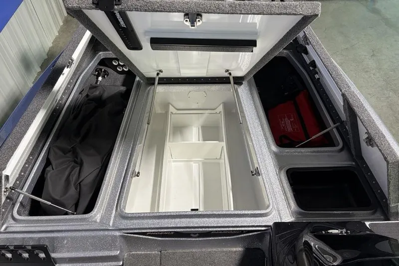 Slide: The Image of 2024 Phoenix 920 Elite boat storage compartments with open lids, showcasing organized interior space. - 6