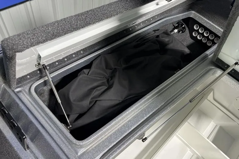Slide: The Image of Open storage compartment in 2024 Phoenix 920 Elite boat, featuring hydraulic lift supports. - 7