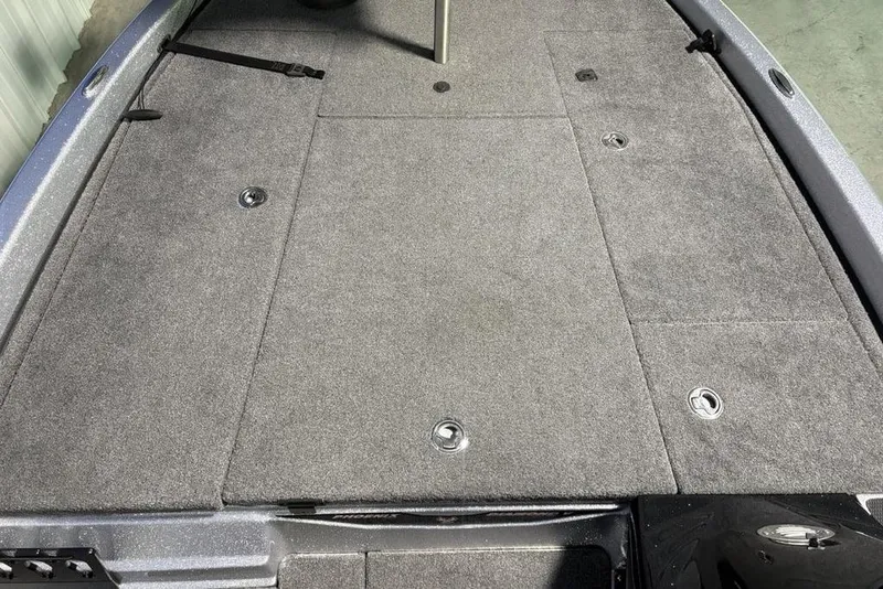 Slide: The Image of 2024 Phoenix 920 Elite boat deck with gray carpet and storage compartments. - 9