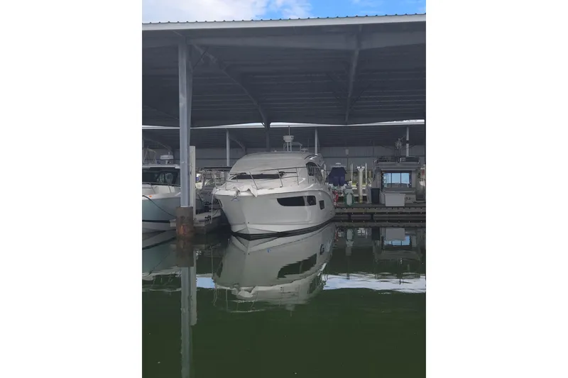 Slide: The Image of 2017 Sea Ray Sundancer 400 yacht interior with teak flooring and seating area. - 10