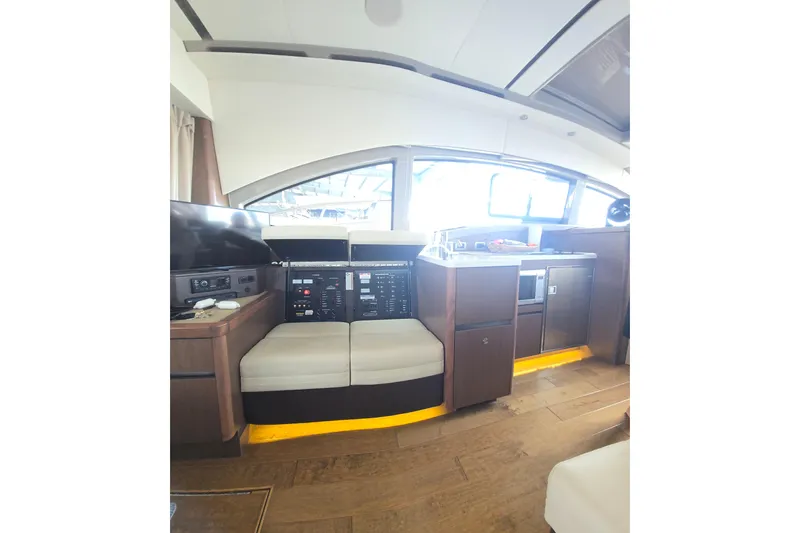 Slide: The Image of 2017 Sea Ray Sundancer 400 interior with modern kitchen and seating area. - 14