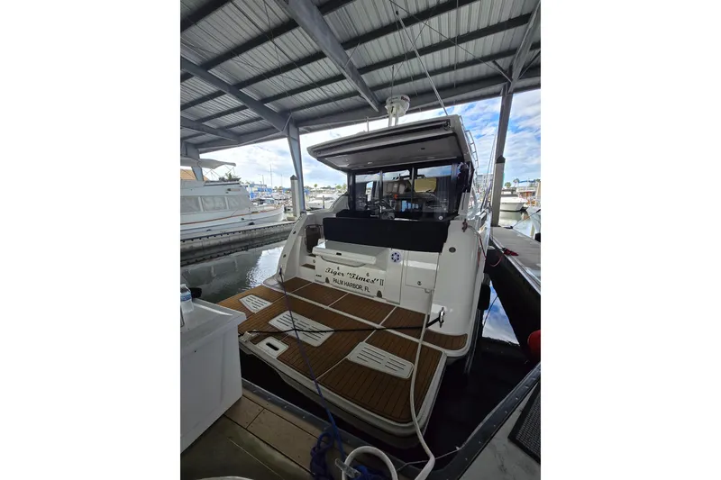 Slide: The Image of Closet interior on 2017 Sea Ray Sundancer 400 with clothes and fire extinguisher. - 22