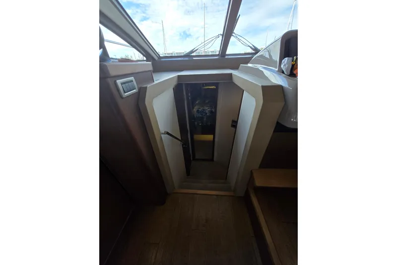 Slide: The Image of 2017 Sea Ray Sundancer 400 interior cabinet with open door revealing equipment. - 31