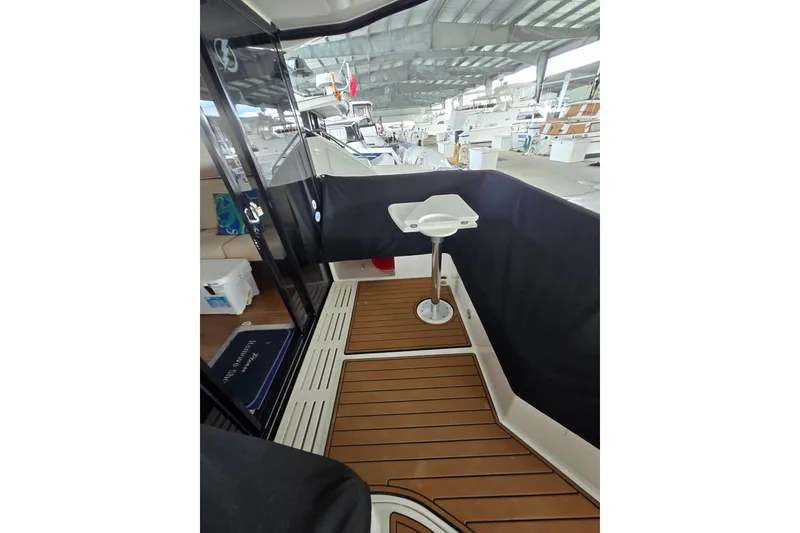 Slide: The Image of 2017 Sea Ray Sundancer 400 yacht docked, featuring spacious deck and seating area. - 9