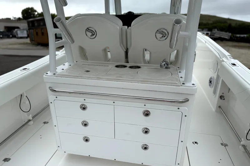 Slide: The Image of 2023 Edgewater 285CC boat interior with storage drawers and seating. - 15