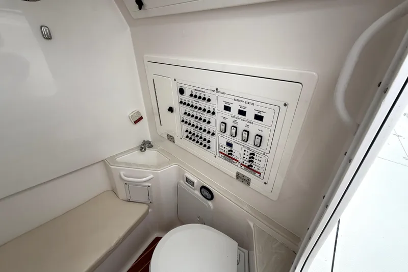 Slide: The Image of 2023 Edgewater 285CC boat interior with control panel and compact sink area. - 16