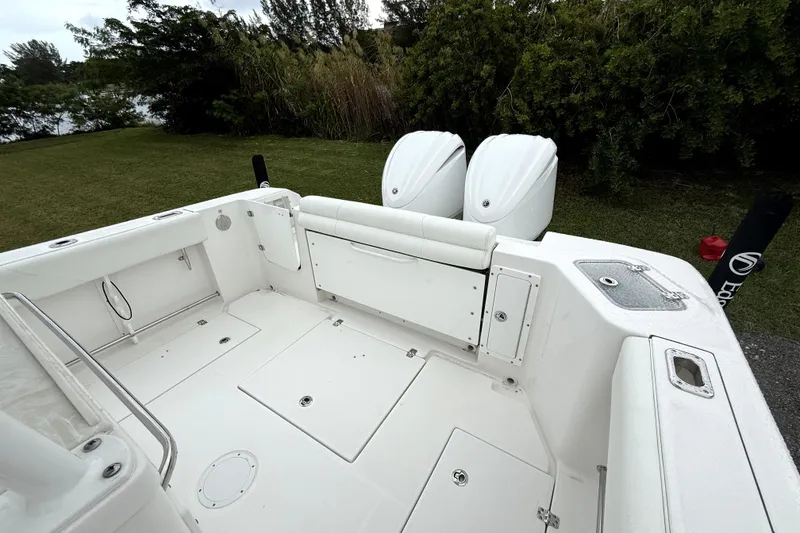 Slide: The Image of 2023 Edgewater 285CC boat interior with dual engines, spacious deck, and sleek design. - 5
