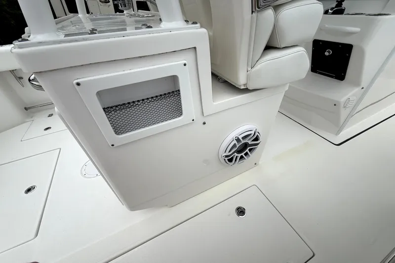 Slide: The Image of 2023 Edgewater 285CC boat interior with speaker and storage compartment. - 7