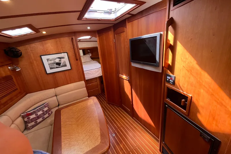 Slide: The Image of Luxurious interior of 2004 Sabre 42 Hardtop Express yacht with wood paneling and cozy seating. - 11