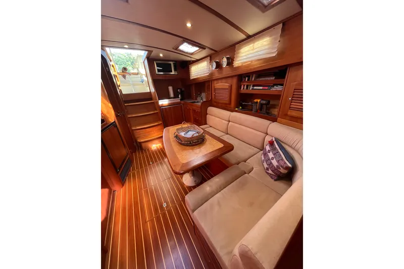 Slide: The Image of Luxurious interior of 2004 Sabre 42 Hardtop Express yacht with wooden flooring and cozy seating. - 15