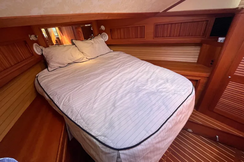 Slide: The Image of Cozy cabin interior of 2004 Sabre 42 Hardtop Express with wooden accents and comfortable bedding. - 22
