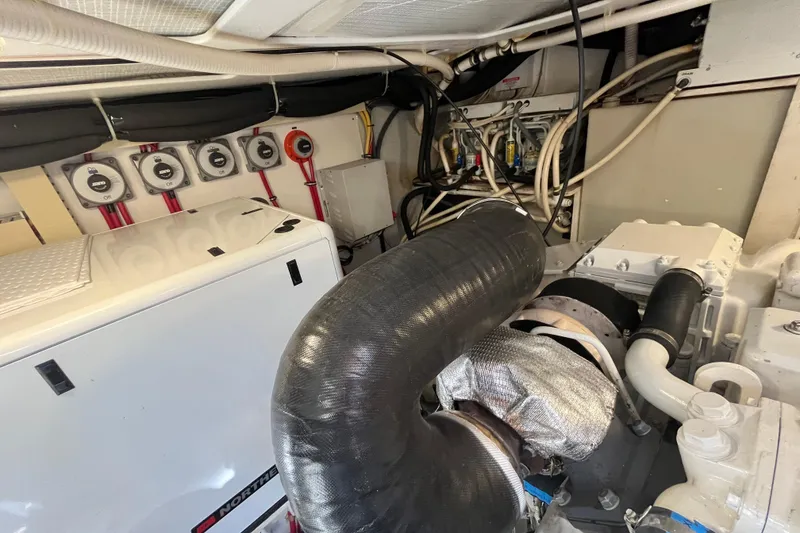 Slide: The Image of Engine room of 2004 Sabre 42 Hardtop Express with visible machinery and wiring. - 25