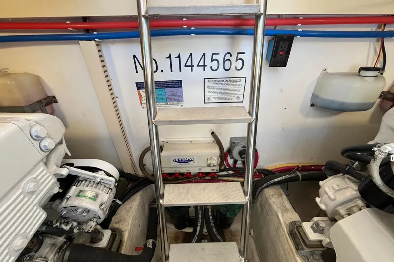 Slide: The Image of Engine room of 2004 Sabre 42 Hardtop Express with ladder and equipment. - 26