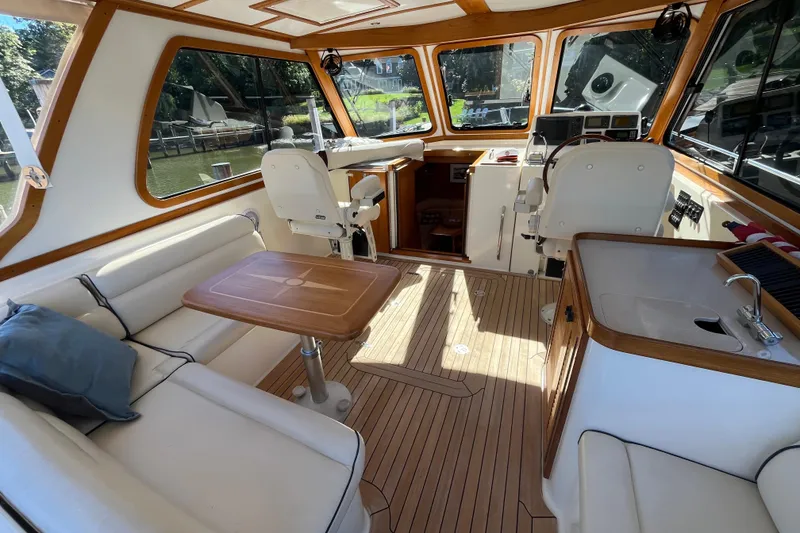 Slide: The Image of Interior of 2004 Sabre 42 Hardtop Express yacht with seating, table, and helm station. - 5