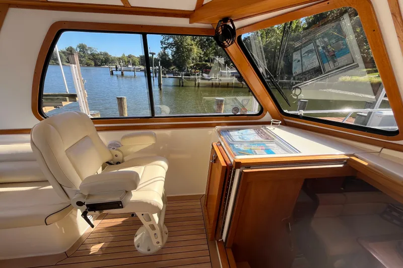 Slide: The Image of Interior of 2004 Sabre 42 Hardtop Express yacht with helm chair and scenic water view. - 6