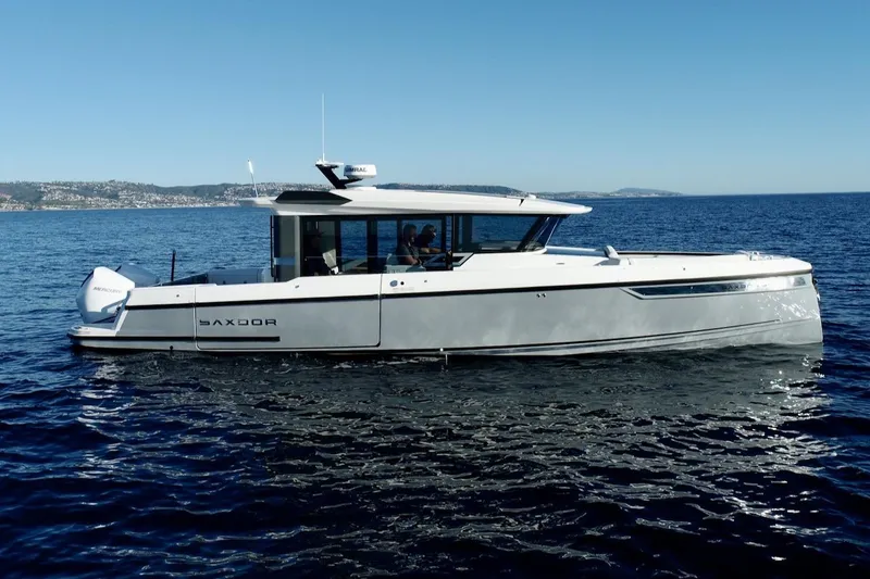 The Image of 2026 Saxdor 340 GTWA boat cruising on open water under clear blue skies. - 23