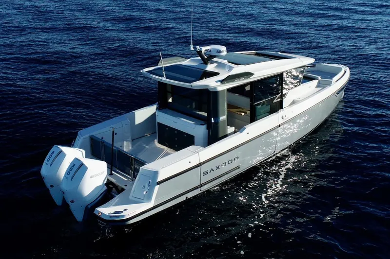 Slide: The Image of 2026 Saxdor 340 GTWA boat cruising on open water, featuring twin Mercury engines. - 27