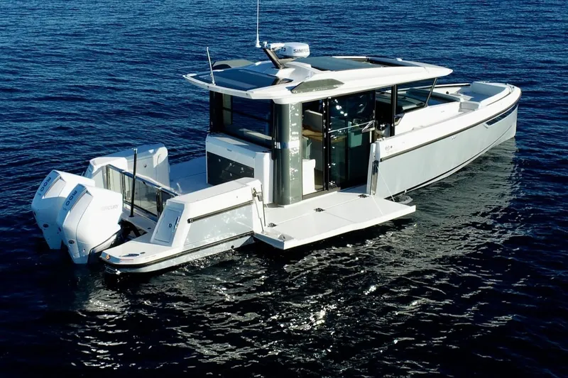 Slide: The Image of 2026 Saxdor 340 GTWA boat on calm blue water, featuring sleek design and twin engines. - 32