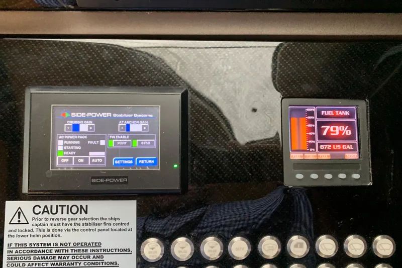 Slide: The Image of Control panel of a 2016 Sunseeker Manhattan 65 yacht, showing stabilizer and fuel tank levels. - 12