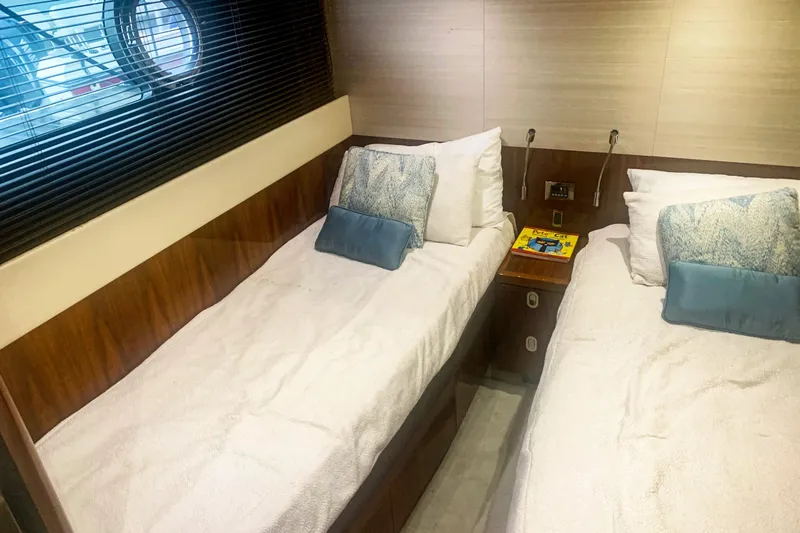 Slide: The Image of Luxurious twin cabin in 2016 Sunseeker Manhattan 65 yacht, featuring elegant bedding and decor. - 20