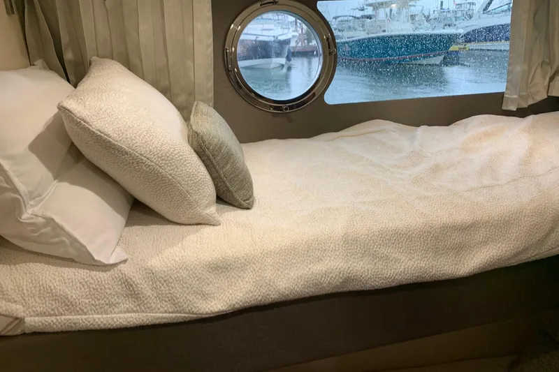 Slide: The Image of Cozy cabin bed in 2016 Sunseeker Manhattan 65 yacht with porthole view. - 21