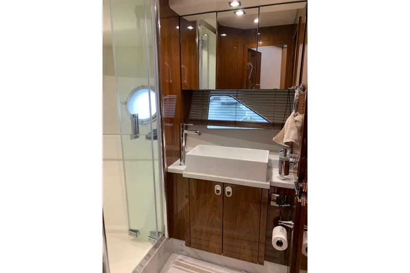 Slide: The Image of Luxurious bathroom in 2016 Sunseeker Manhattan 65 yacht with modern fixtures and wood accents. - 22