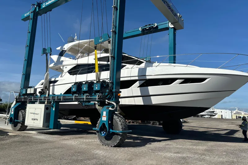 Slide: The Image of 2016 Sunseeker Manhattan 65 yacht on a travel lift at a marina. - 24