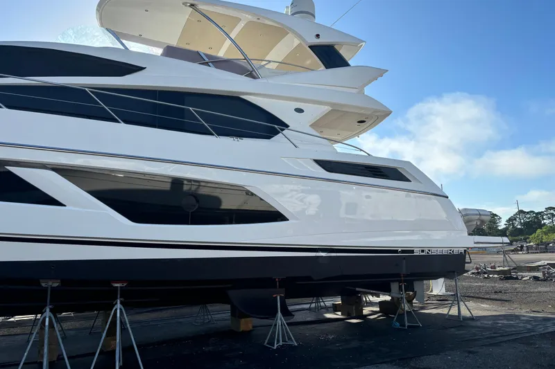 Slide: The Image of 2016 Sunseeker Manhattan 65 yacht on dry dock under clear blue sky. - 31