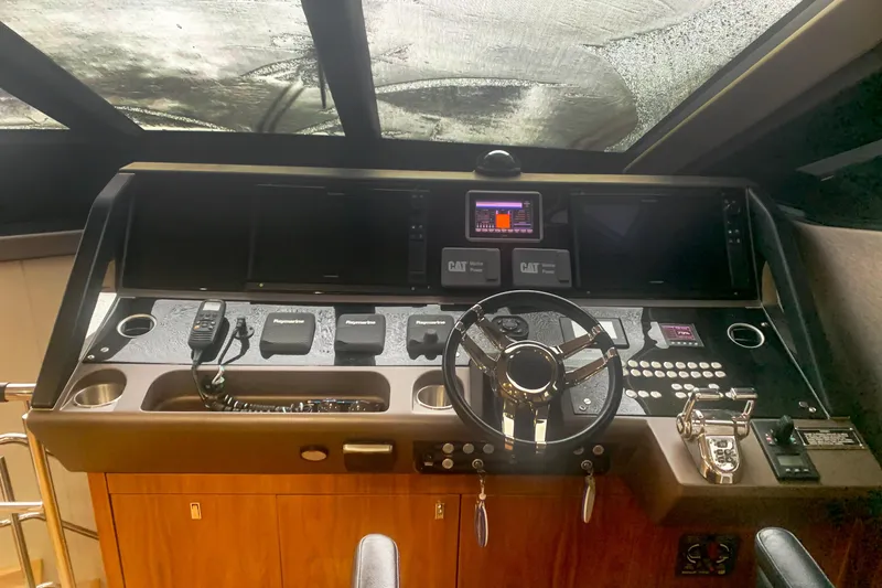 Slide: The Image of Cockpit of 2016 Sunseeker Manhattan 65 yacht with advanced navigation controls. - 9