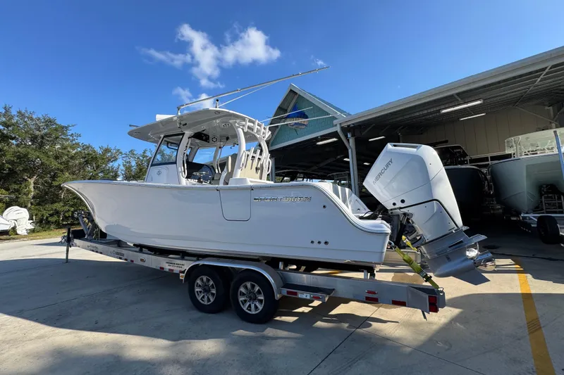 Slide: The Image of 2024 Sportsman Open 302 Center Console boat on trailer, parked outdoors. - 14