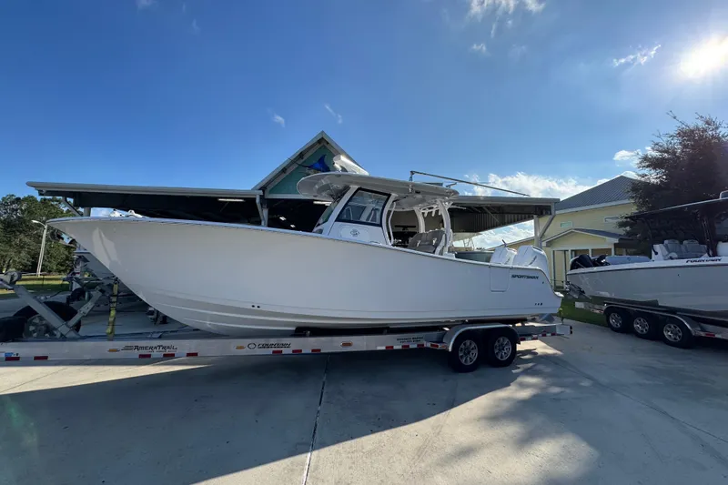Slide: The Image of 2024 Sportsman Open 302 Center Console boat on trailer under clear blue sky. - 2