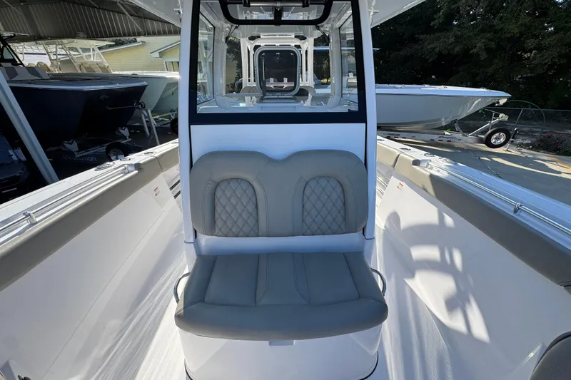 Slide: The Image of 2024 Sportsman Open 302 Center Console boat interior with cushioned seating. - 22