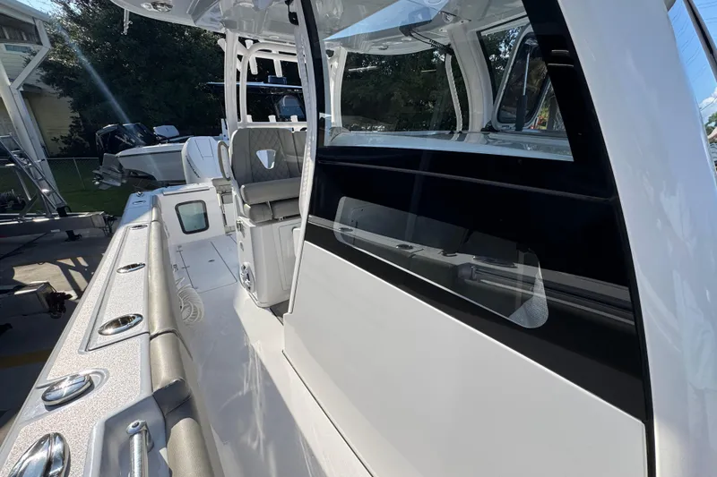 Slide: The Image of 2024 Sportsman Open 302 Center Console boat, featuring sleek design and modern amenities. - 24