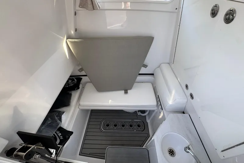 Slide: The Image of 2024 Sportsman Open 302 Center Console interior with seating and sink. - 25