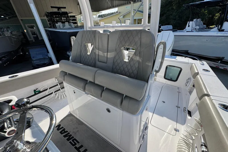 Slide: The Image of 2024 Sportsman Open 302 Center Console boat interior with cushioned seating and steering wheel. - 27