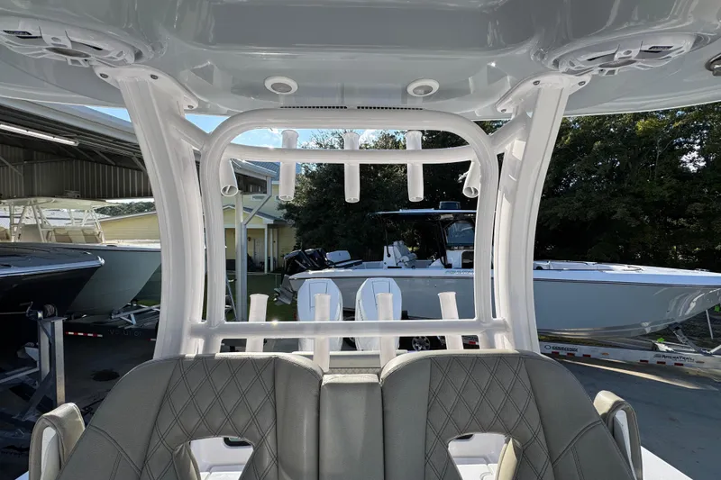 Slide: The Image of 2024 Sportsman Open 302 Center Console boat interior with rod holders and seating. - 29