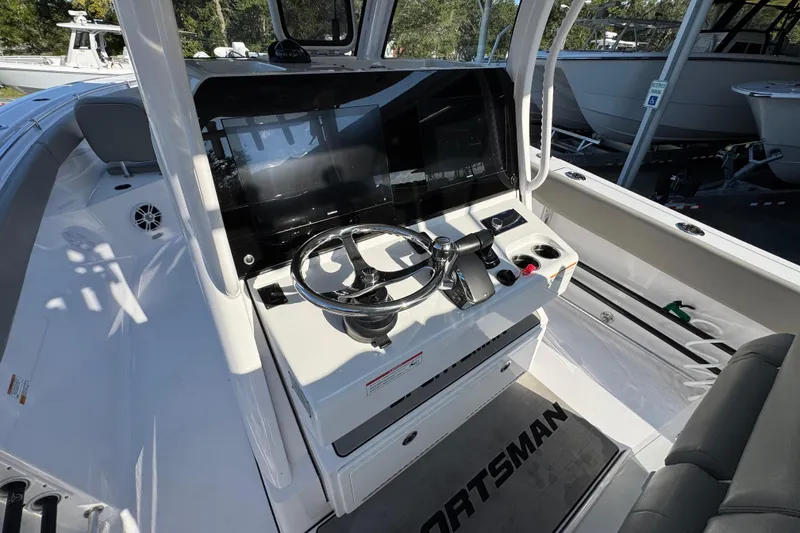 Slide: The Image of 2024 Sportsman Open 302 Center Console boat interior with modern steering and controls. - 30