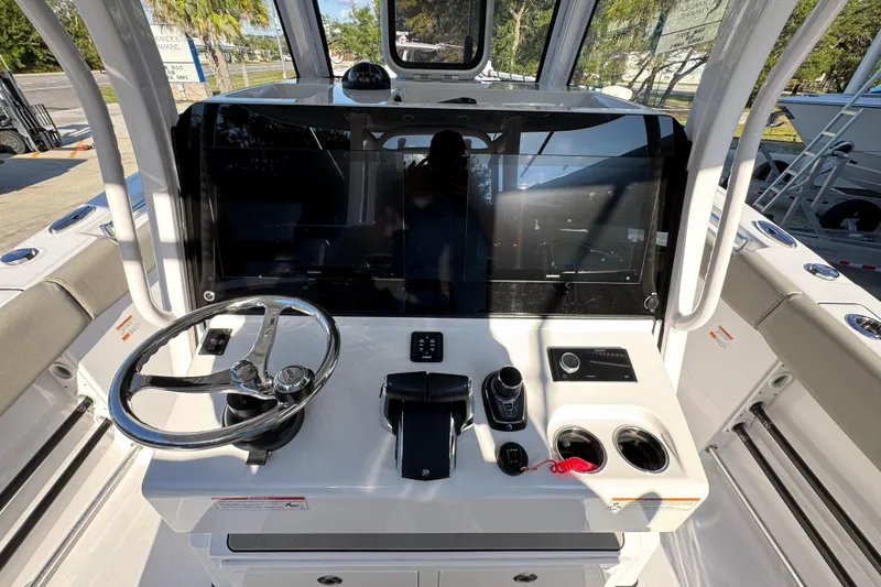 Slide: The Image of 2024 Sportsman Open 302 Center Console helm with steering wheel and controls. - 31