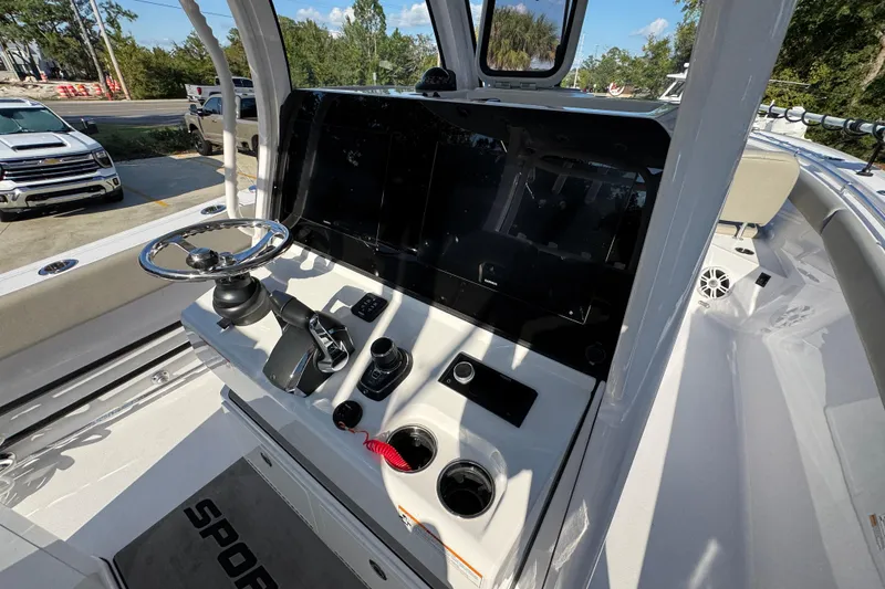 Slide: The Image of 2024 Sportsman Open 302 Center Console boat interior with steering wheel and controls. - 35