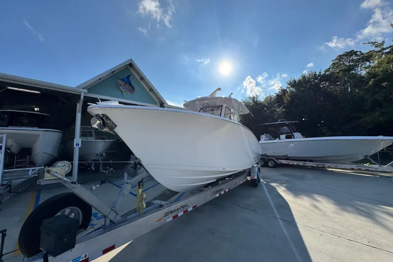 Slide: The Image of 2024 Sportsman Open 302 Center Console boat on trailer under sunny sky. - 4