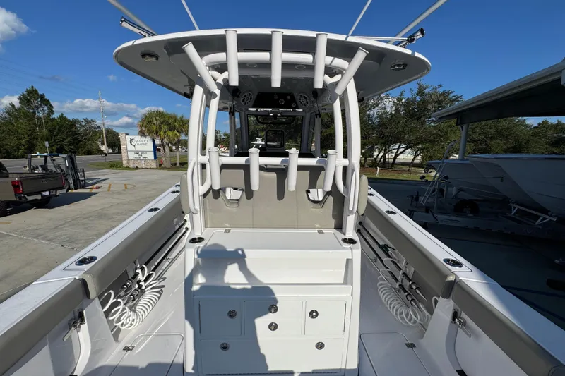 Slide: The Image of 2024 Sportsman Open 302 Center Console boat, featuring spacious deck and rod holders. - 40