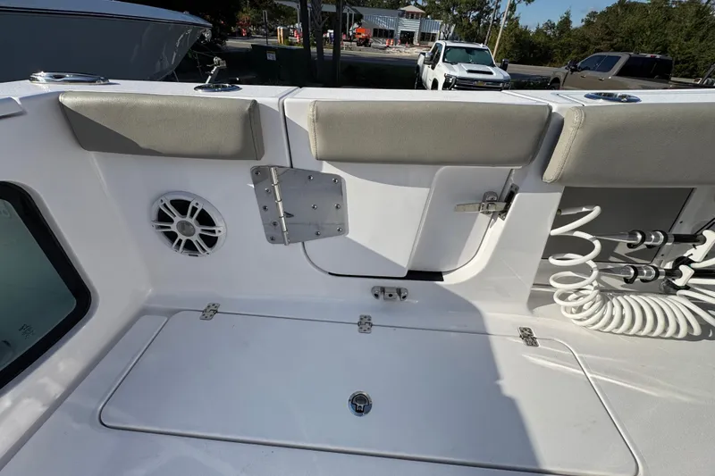 Slide: The Image of 2024 Sportsman Open 302 Center Console boat interior with seating and storage. - 42