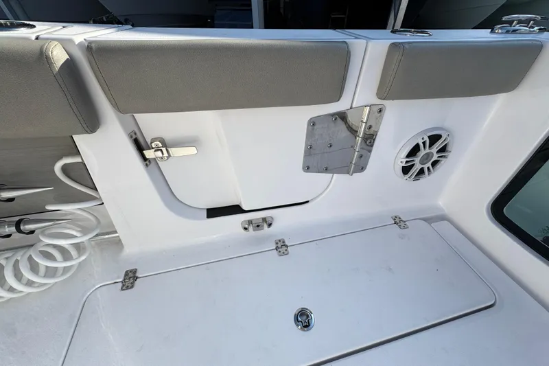 Slide: The Image of 2024 Sportsman Open 302 Center Console interior with storage, speaker, and seating. - 43