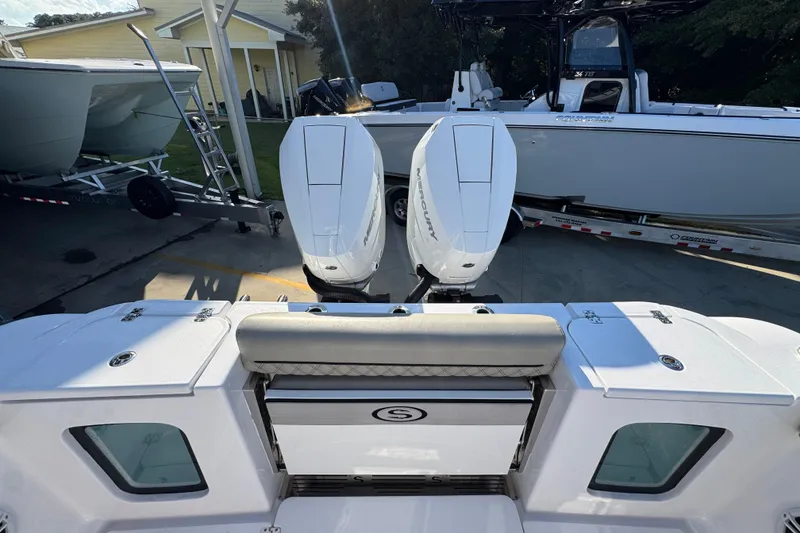 Slide: The Image of 2024 Sportsman Open 302 Center Console with dual Mercury engines, docked outdoors. - 48