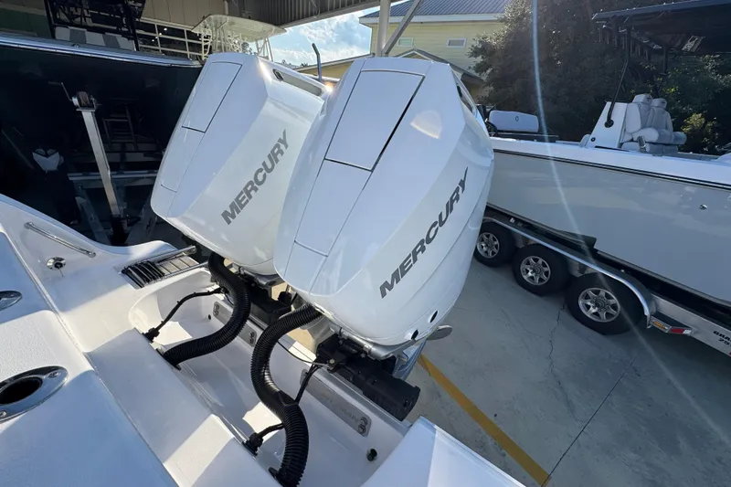 Slide: The Image of 2024 Sportsman Open 302 Center Console with dual Mercury outboard engines. - 49