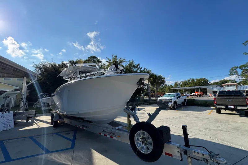 Slide: The Image of 2024 Sportsman Open 302 Center Console boat on trailer under clear blue sky. - 6